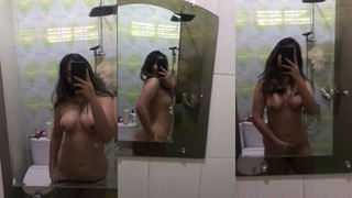 Sexy desi indian teen show off big tits and hairy pussy in bathroom