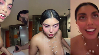 A woman filming a live stream with three men.