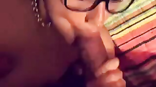 girl with glasses sucking her boyfriend's cock